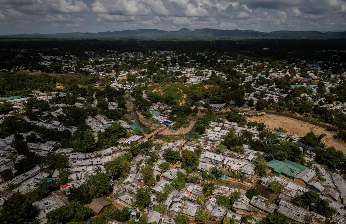Aerial view of Camp 5 in Cox's Bazar, Bangladesh, with shelters, trees and mountains